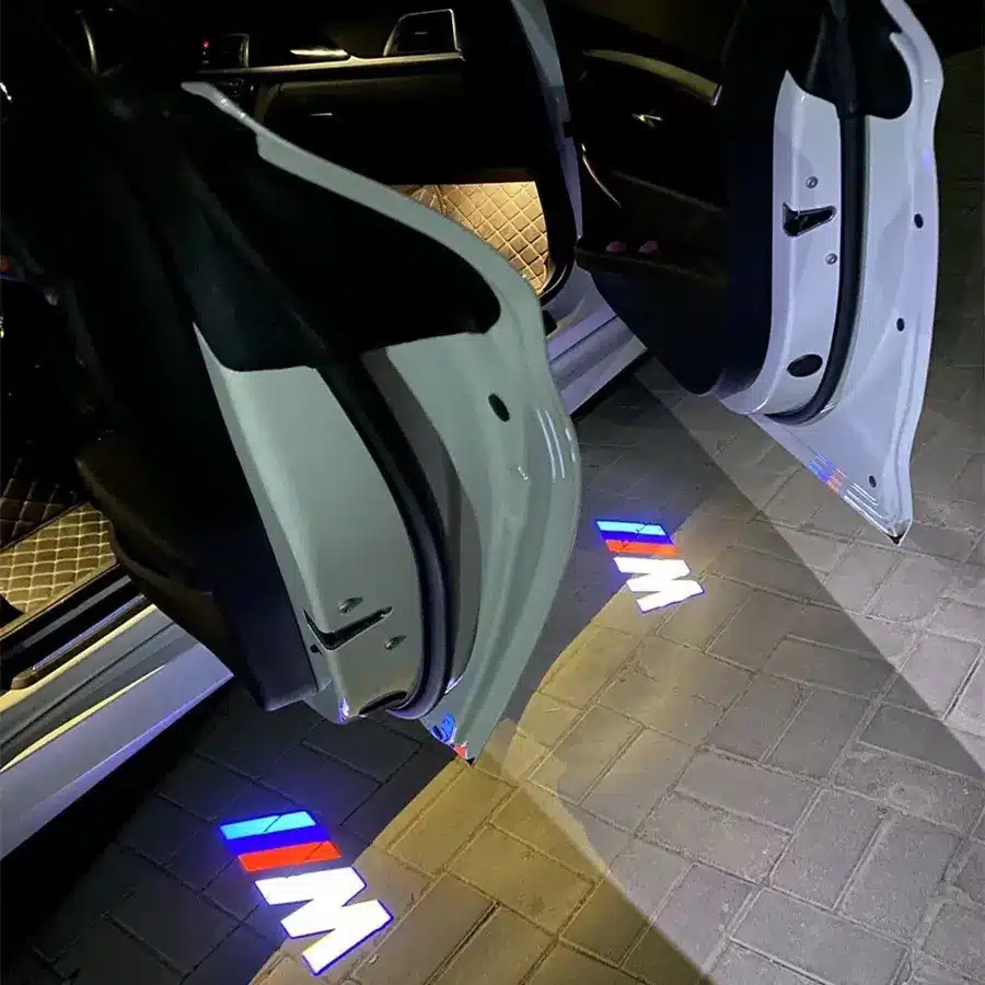 BMW M Door Lights| LED BMW M Door Lights Car doors open at night, projecting the "M" logo with red, blue, and white colors onto the ground, creating a modern and stylish effect.