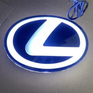 Lexus illuminated front emblem — white LED glow on grille